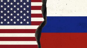 American and Russian flag pair on cracked wall. Horizontal 